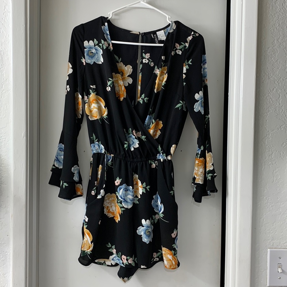 Black floral romper with long sleeves and pockets
